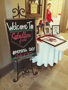 a table with a sign that says welcome to caterher's field opening day