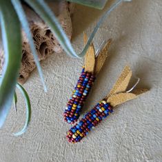 Size 11 Japanese seed beads in a corn cob shape with deerskin leather as husk. Each bead in the cob has a minimum of five threads woven through it. The base color is brick, with navy being heavily second used. Other colors are: moody blue, hawthorne, sienna, and banana. Earrings hang about 2" long from top of sterling silver hooks [with rubber backings] to bottom bead. Packaged in a jewelry box with ribbon bow. Shipped via USPS with Tracking. Made in a pet free, smoke free, and peanut free home. 100% Native American made with love. My earrings are made for everyone. Thank you for supporting Indigenous made and not Indigenous inspired. Flint Corn, Banana Earrings, Corn Earrings, Native Crafts, Corn Cob, Nativity Crafts, Corn On Cob, Peanut Free, Deer Skin