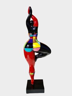 a colorful sculpture of a woman doing yoga