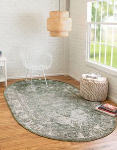 a round rug in a room with white walls and wooden flooring, next to a chair