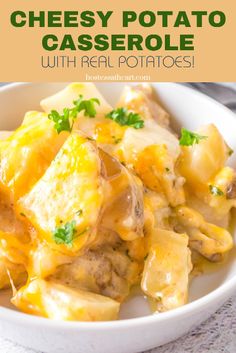 cheesy potato casserole with real potatoes in a white bowl