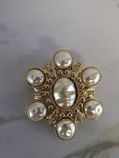 "Vintage St John Gold Tone Hammered Pearl and Rhinestone Brooch Excellent pre-owned vintage condition. All pearls and rhinestones are intact set in bright gold tone metal Pin on back, but also has hinge to be a necklace pendant 2.25\" in diameter Purchased in 2003 for $125" Gold Jeweled Brooches For Formal Occasions, Formal Gold Jeweled Brooches, Victorian Jeweled Gold Brooches, Ornate Jeweled Gold Brooches, Ornate Gold Jeweled Brooches, Vintage Gold-tone Brooches For Formal Occasions, Gold Jeweled Costume Jewelry Brooch, Gold Brooches With Rhinestones For Anniversary, Gold Jeweled Brooches For Wedding