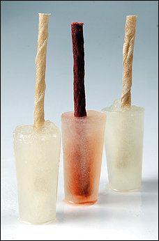 three glasses with straws in them sitting next to each other on a white surface