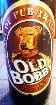 a close up of a bottle of beer with a dog on the front and side