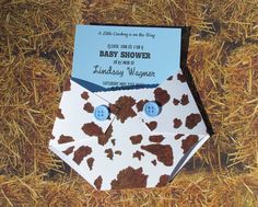 an origami style baby shower with brown and white designs on it, sitting in hay