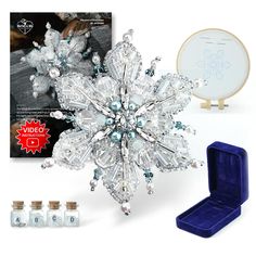 a snowflake ornament is shown next to its box and instructions for how to make it