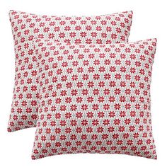 two red and white pillows sitting next to each other