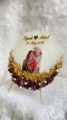 an ornament with a photo on it sitting on a white furnishing