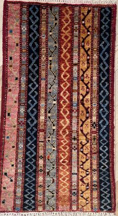 an old rug with many different colors and patterns