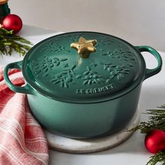 a green casserole sitting on top of a white counter next to christmas decorations