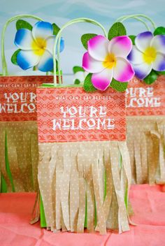 two paper bags with flowers on them and the words you're welcome in advance