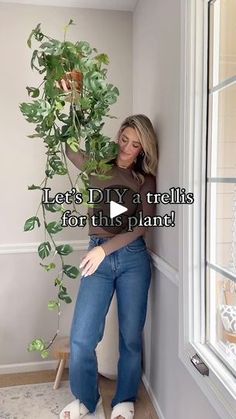 a woman leaning against a wall holding a potted plant with the words let's diy a trellis for the plant