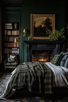 a bedroom with dark green walls and a fireplace in the corner is furnished with plaid bedding