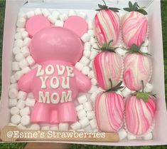 a box filled with pink and white chocolate covered strawberries next to a teddy bear