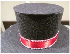 a black top hat with a red ribbon around it