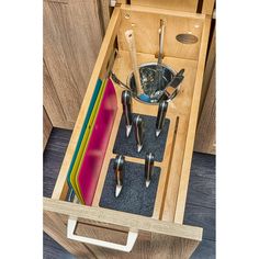 an open drawer with utensils in it