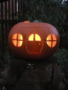 a pumpkin carved to look like an elephant's head with glowing eyes and mouth