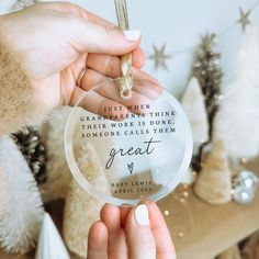 someone is holding up a glass ornament with the words great written on it