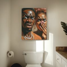 a bathroom scene with focus on the toilet and two women's faces painted on the wall