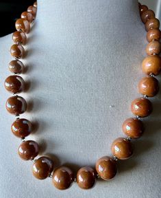 "This Kazuri necklace is 21\" long, earth tone/light brown medium-size beads with a beautiful glaze giving it a nice simmer. Very understated and versatile color. Kazuri beads are made of the special king of the Mount Kenya clay,  handcrafted individually by trained women artisans. They are kiln fired,  glazed, and fired again before being strung. Each piece is unique. By purchasing this creative piece of jewelry you are helping to support a young  Kenyan girl with her educational expenses. 100%  of the profit goes to our Women Children and Education program. Without our support, these young girls have no other means to obtain an education.  We thank you in advance." Kazuri Bead Jewelry, Kazuri Beads, Mount Kenya, An Education, Women Artisans, Earth Tones, Kiln, Kenya, Medium Size