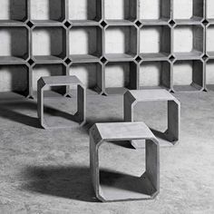 three concrete benches sitting next to each other in front of a book shelf filled with books