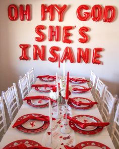 the table is set with red plates and silverware for an elegant valentine's day dinner