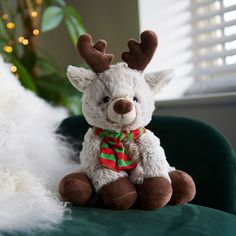 a stuffed reindeer sitting on top of a green chair