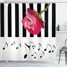 a shower curtain with music notes and a pink rose on the piano keys in black and white