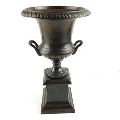 an ornate bronze urn is on display against a white background