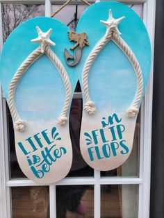 two flip flops are hanging on the window sill