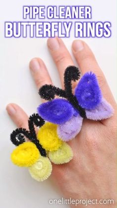 a hand is holding three pieces of pipe cleaner ring with the words how to make pipe cleaner butterfly rings