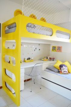 a yellow bunk bed sitting next to a white desk