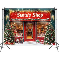 santa's shop with christmas trees and presents on display in front of the store