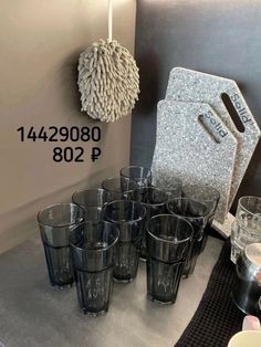 a bunch of glasses are sitting on a table with the price tag for each one