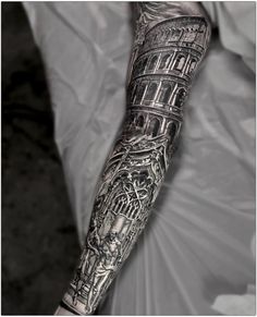 a man's arm is covered in tattoos and has a clock tower on it