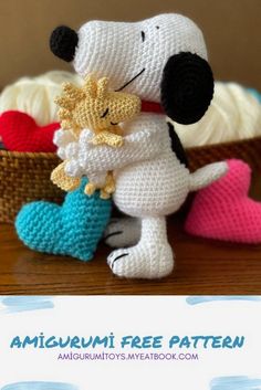 there is a crochet dog that is hugging another dog