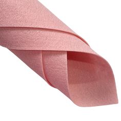 a roll of pink colored paper on a white background