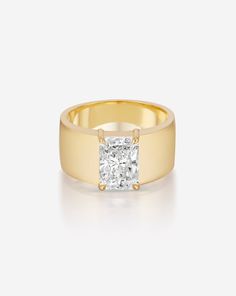 a yellow gold ring with a princess cut diamond