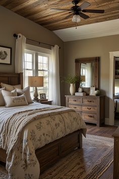 a bedroom with a bed, dressers and mirror in it's center area