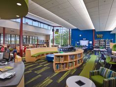 a library with tables, chairs and bookshelves