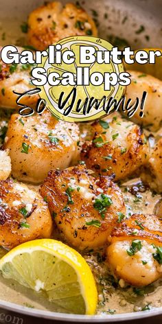 garlic butter scallops in a pan with lemon wedges