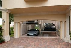 two cars are parked in the garage under an awning