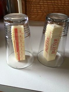 two glass jars with fake toothbrushes in them