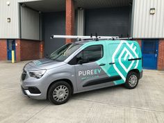 a silver van parked in front of a building