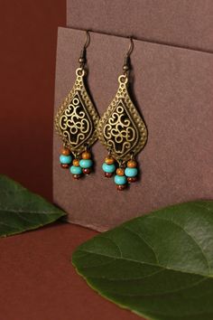 "These unique boho earrings was made of big drop shape antique brass charms, tiny czech glass \"picasso\" style blue,brown beads and antiqie brass earring hooks. Earring hooks are from nickel free and lead free metal. A wonderful jewelry for you or an unique gift for someone speacial! *The total lenght of earrings is about 67 mm including earring hooks. Other earrings of my shop you can see here: https://www.etsy.com/shop/NaTavelli?section_id=13757927 Thanks for visit." Brass Chandelier Earrings For Festivals, Brass Chandelier Drop Earrings For Festival, Bohemian Teardrop Pierced Earrings, Bohemian Bronze Chandelier Earrings For Pierced Ears, Brass Dangle Chandelier Earrings For Festivals, Bohemian Bronze Pierced Chandelier Earrings, Bohemian Bronze Chandelier Earrings, Bronze Bohemian Chandelier Earrings, Brass Dangling Beads Earrings For Festivals