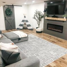 the living room is clean and ready to be used for christmas decorations, including a teepee