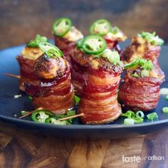 bacon wrapped in jalapenos on a blue plate