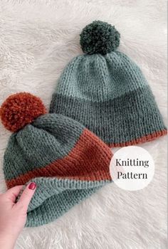 a knitted hat with two pom poms on top and the text knitting pattern below it