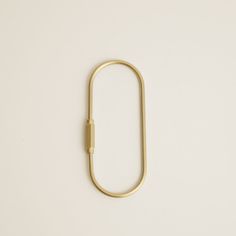 a gold paper clip on a white background