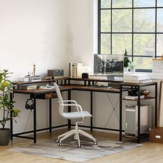 an office with a desk, chair and computer on the floor in front of a window